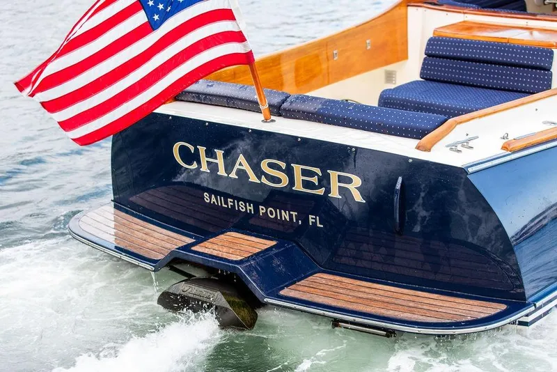 Slide: The Image of 2004 Hinckley Picnic Boat EP with American flag, named "Chaser," at Sailfish Point, FL. - 5