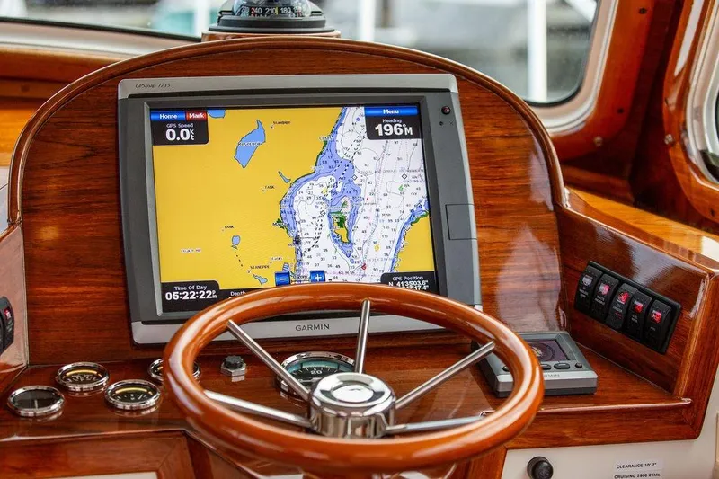 Slide: The Image of Hinckley Picnic Boat EP 2004 helm with GPS navigation system and wooden steering wheel. - 15
