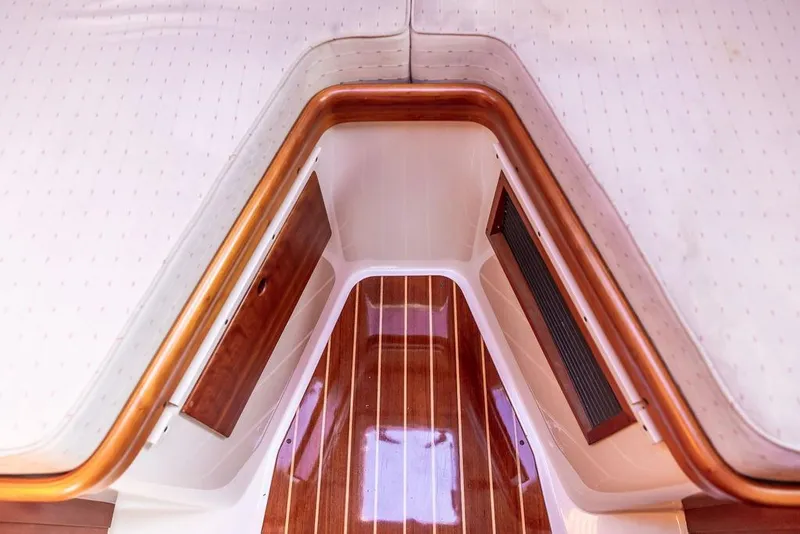 Slide: The Image of Interior of 2004 Hinckley Picnic Boat EP with wood accents and striped flooring. - 21