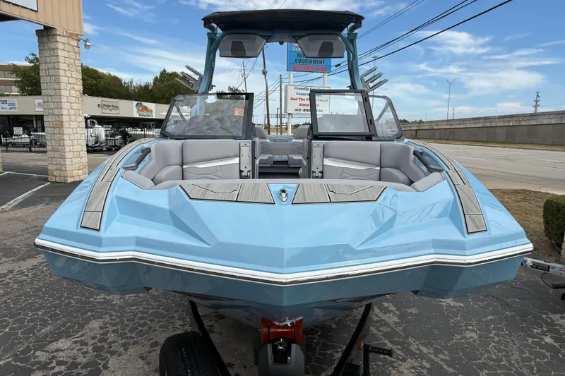 Slide: The Image of 2026 Supa SA 550 boat in light blue, parked outdoors on a trailer. - 2