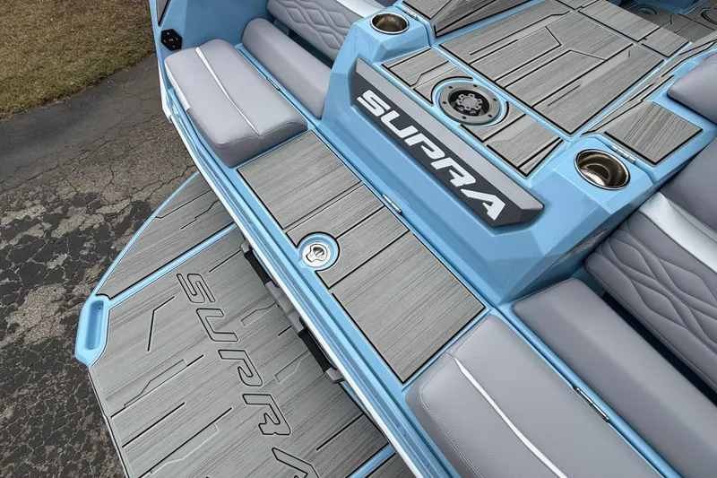 Slide: The Image of Blue 2026 Supa SA 550 boat interior with gray seating and deck, featuring "SUPRA" branding. - 7