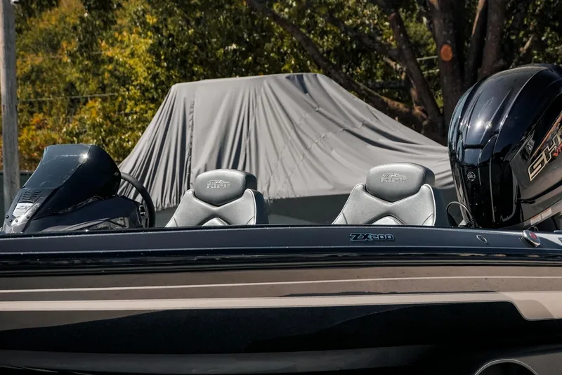 Slide: The Image of 2024 Skeeter ZX200 boat with sleek seats and powerful engine, outdoors. - 12
