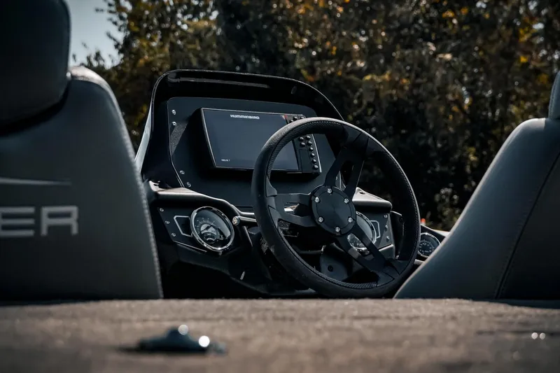 Slide: The Image of 2024 Skeeter ZX200 boat dashboard with steering wheel and navigation display. - 13
