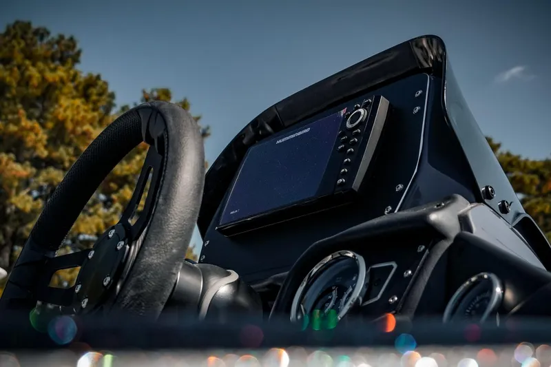 Slide: The Image of 2024 Skeeter ZX200 boat dashboard with steering wheel and electronic display. - 15