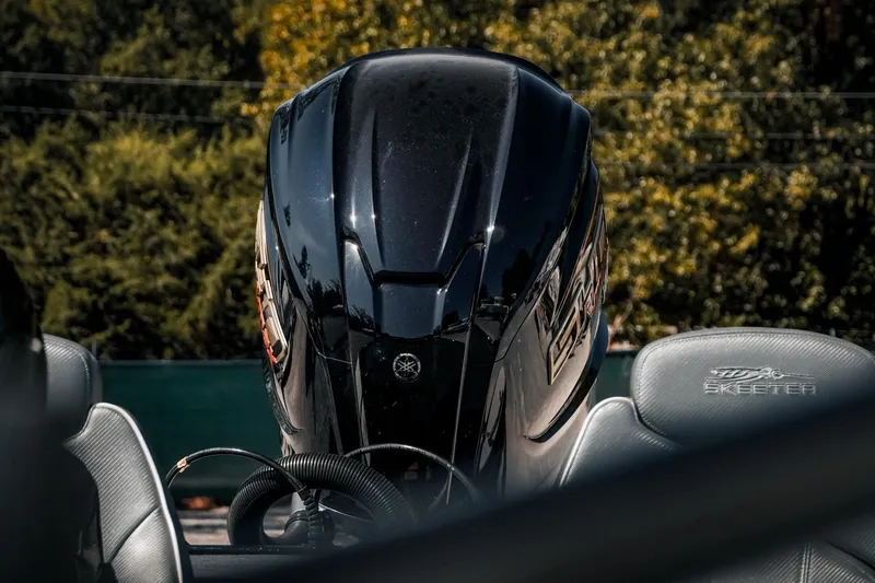 Slide: The Image of 2024 Skeeter ZX200 boat engine with sleek design, surrounded by lush greenery. - 24