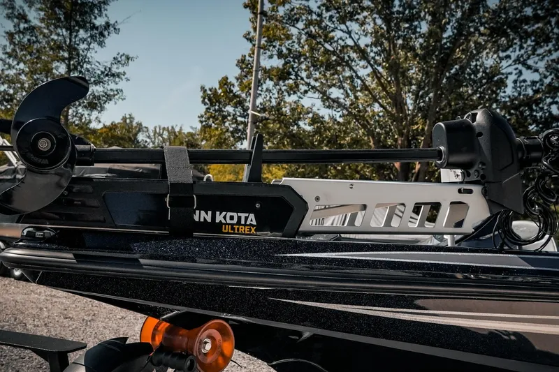 Slide: The Image of 2024 Skeeter ZX200 boat with Minn Kota Ultrex trolling motor, parked outdoors. - 25