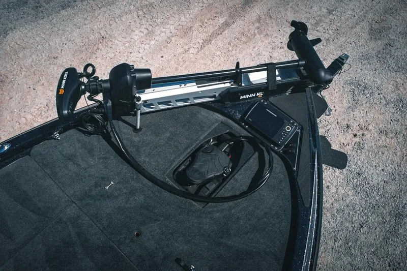 Slide: The Image of 2024 Skeeter ZX200 boat deck with Minn Kota trolling motor and electronic device. - 8