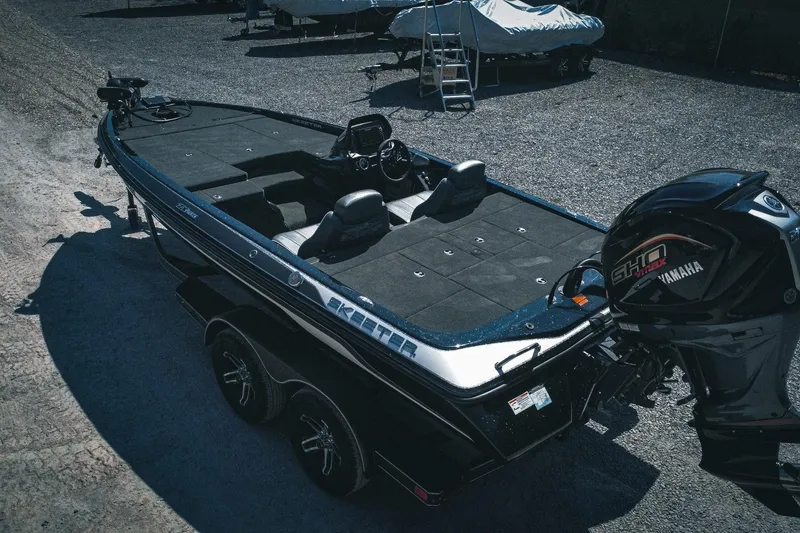 Slide: The Image of 2024 Skeeter ZX200 bass boat with Yamaha engine, parked on gravel. - 9