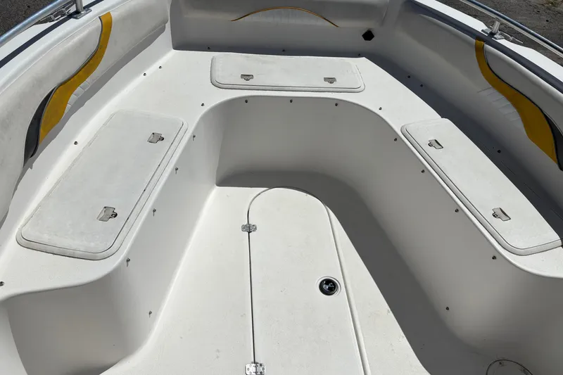 Slide: The Image of 2004 Sea Chaser 2300 Offshore boat interior with storage compartments and seating. - 12