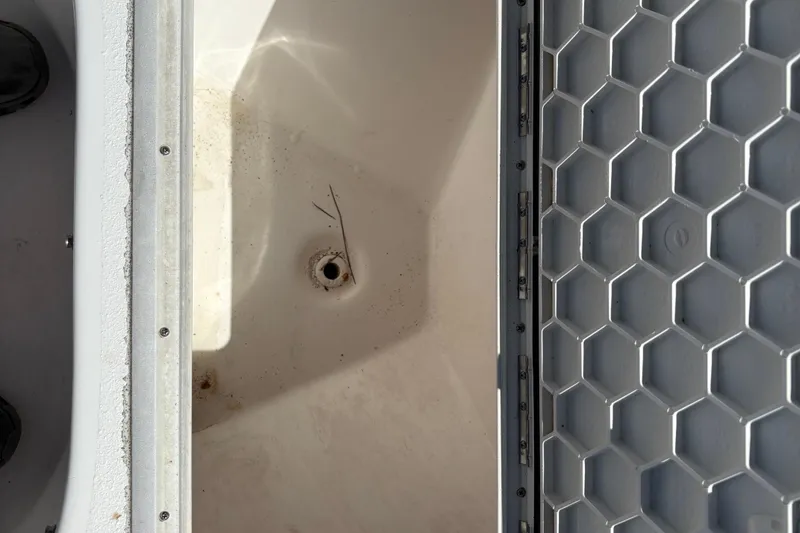 Slide: The Image of Open storage compartment of 2004 Sea Chaser 2300 Offshore boat, showing interior details. - 14