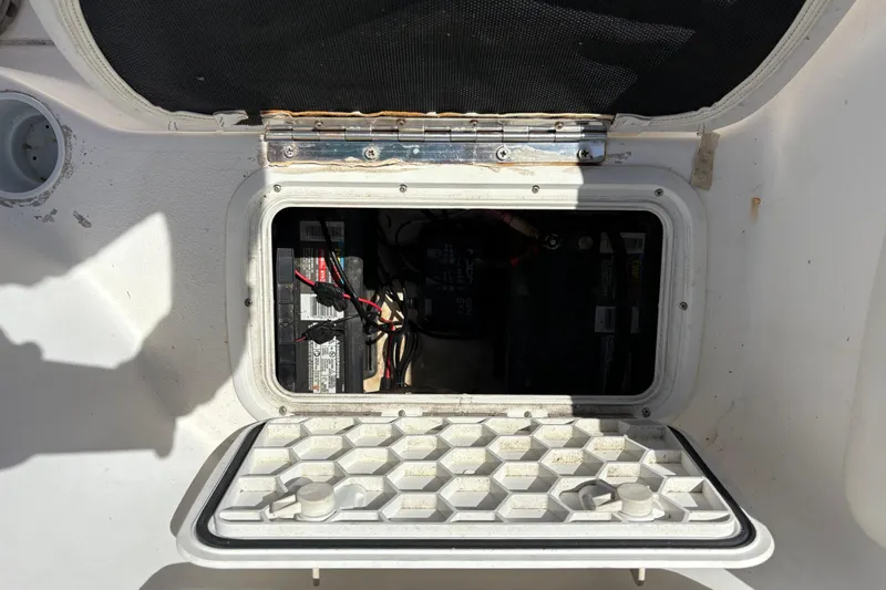 Slide: The Image of Open battery compartment on a 2004 Sea Chaser 2300 Offshore boat. - 21