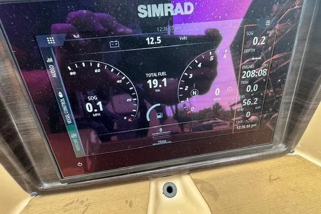 Slide: The Image of Simrad display on 2023 Harris Sunliner 250 showing speed, fuel, and engine data. - 15
