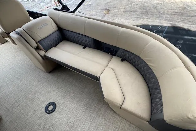 Slide: The Image of 2023 Harris Sunliner 250 boat interior with beige and gray seating. - 18