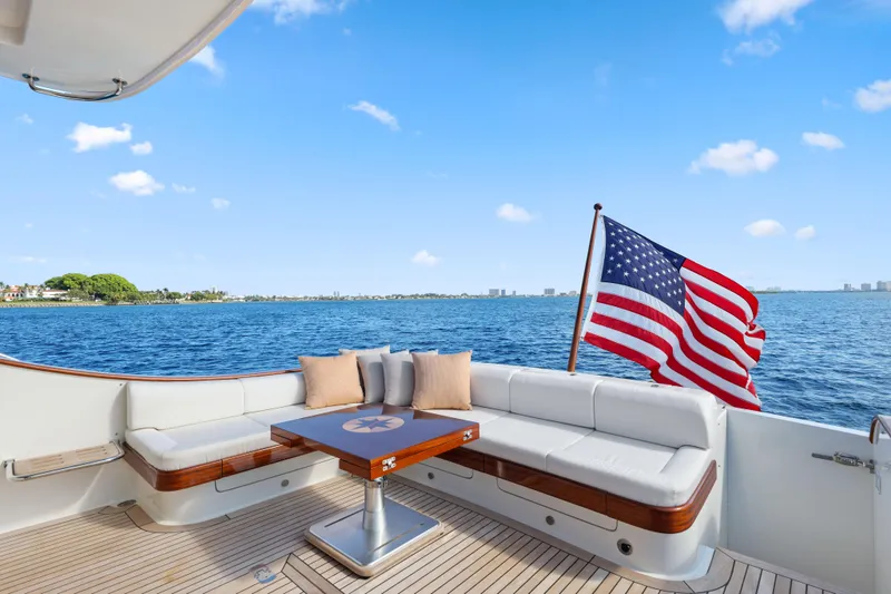 Slide: The Image of 2023 Vicem 65 Classic yacht deck with American flag, ocean view, and seating area. - 12