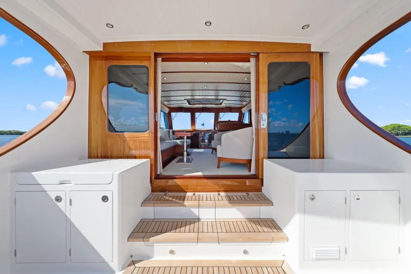 Slide: The Image of Luxurious 2023 Vicem 65 Classic yacht interior with elegant wood finishes and spacious seating. - 15