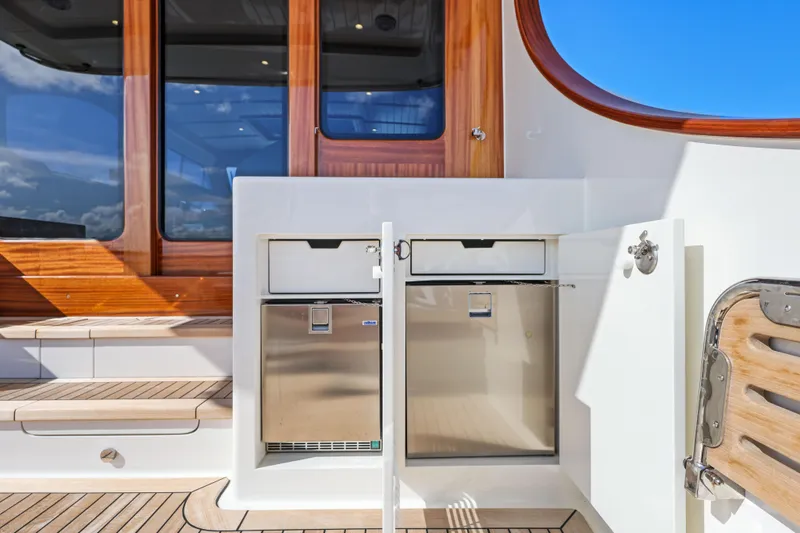 Slide: The Image of 2023 Vicem 65 Classic yacht interior with stainless steel appliances and wooden accents. - 17