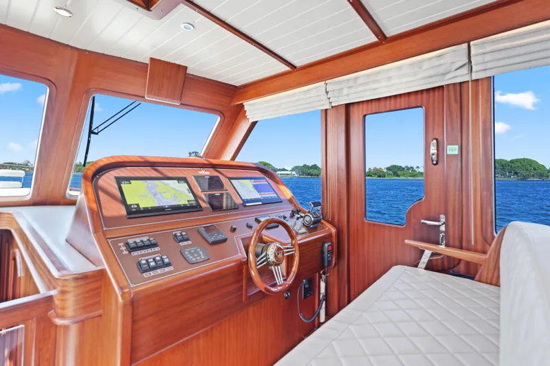 Slide: The Image of 2023 Vicem 65 Classic yacht interior with wooden helm and navigation screens. - 26