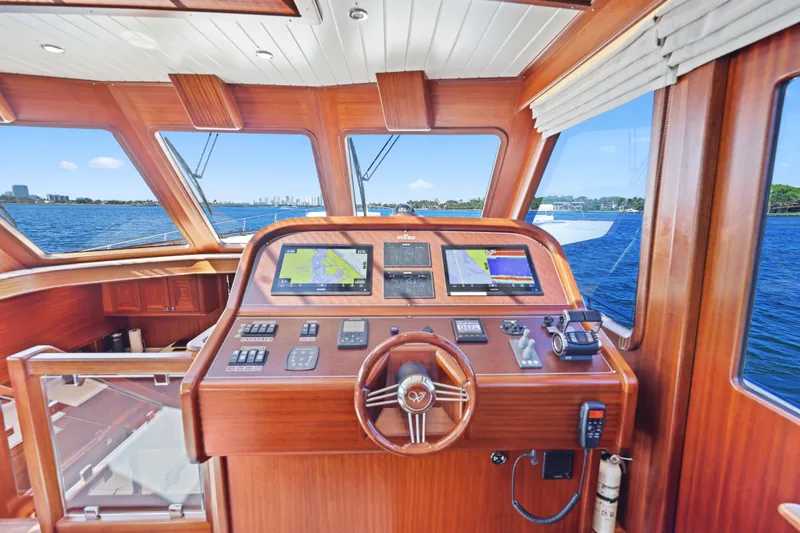 Slide: The Image of Cockpit of 2023 Vicem 65 Classic yacht with navigation screens and wooden steering wheel. - 27