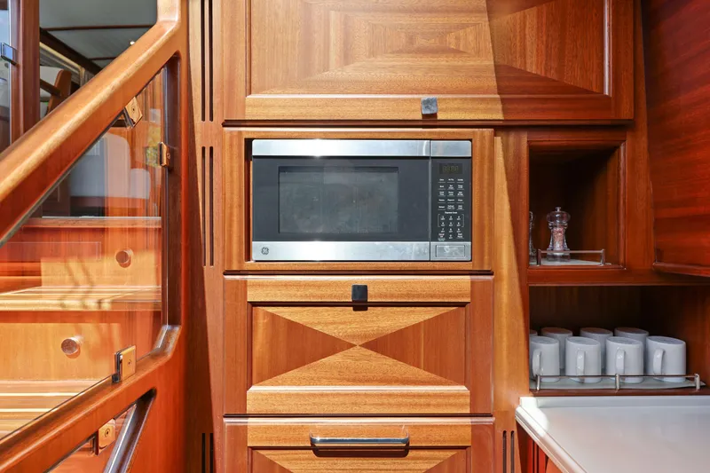 Slide: The Image of 2023 Vicem 65 Classic yacht interior with microwave and wooden cabinetry. - 31
