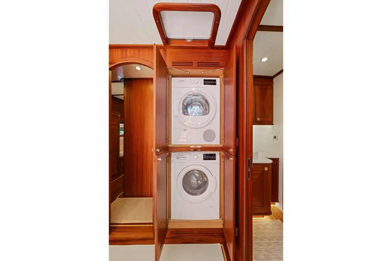 Slide: The Image of Laundry area with stacked washer and dryer in 2023 Vicem 65 Classic yacht. - 32