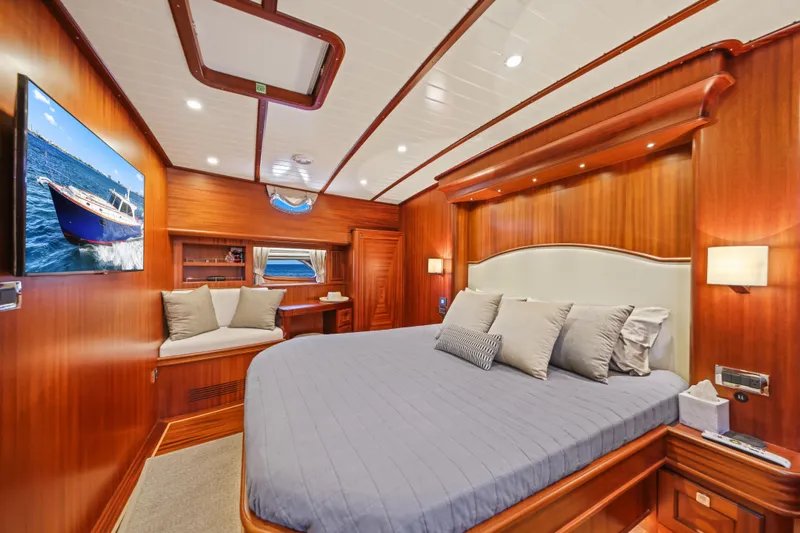 Slide: The Image of Luxurious 2023 Vicem 65 Classic yacht bedroom with elegant wood paneling and modern amenities. - 4