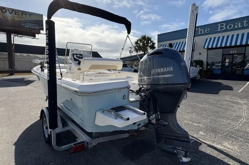 Slide: The Image of 2025 Bulls Bay 2000 boat with Yamaha engine on trailer, parked outside dealership. - 1