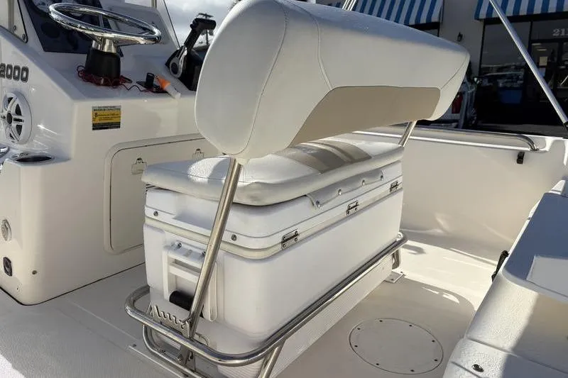 Slide: The Image of 2025 Bulls Bay 2000 boat interior with cushioned seating and steering console. - 11
