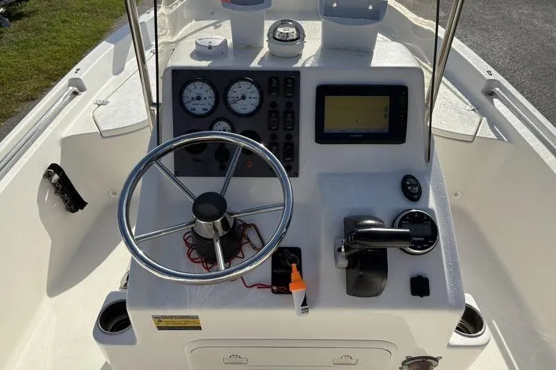 Slide: The Image of Center console of 2025 Bulls Bay 2000 boat with steering wheel and navigation instruments. - 13