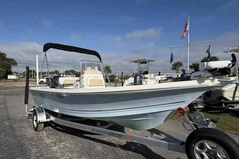 Slide: The Image of 2025 Bulls Bay 2000 boat on trailer, parked outdoors under a clear sky. - 4