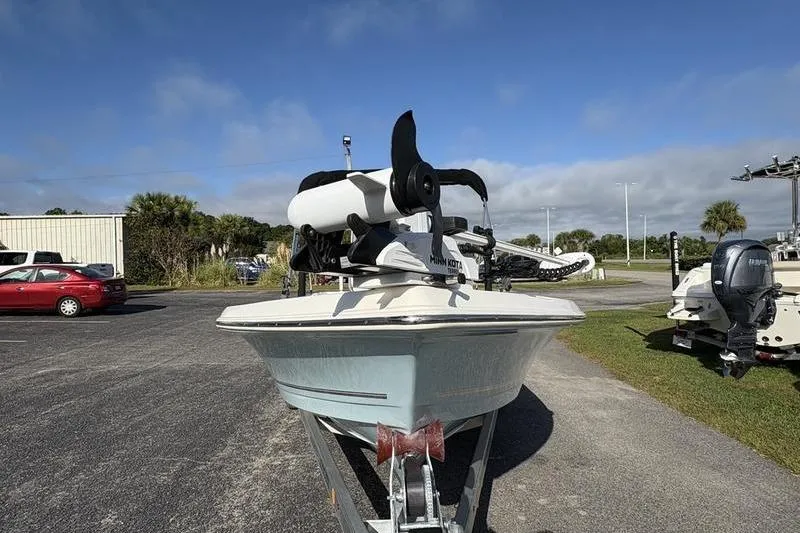 Slide: The Image of 2025 Bulls Bay 2000 boat on trailer with Minn Kota motor, parked outdoors. - 6