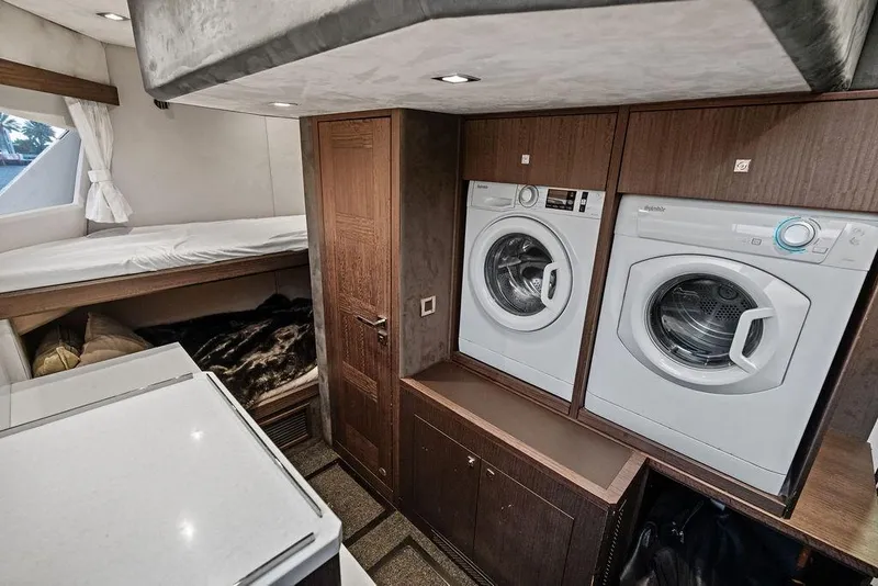Slide: The Image of Laundry area with washer and dryer in 2022 Galeon 640 Fly yacht interior. - 102