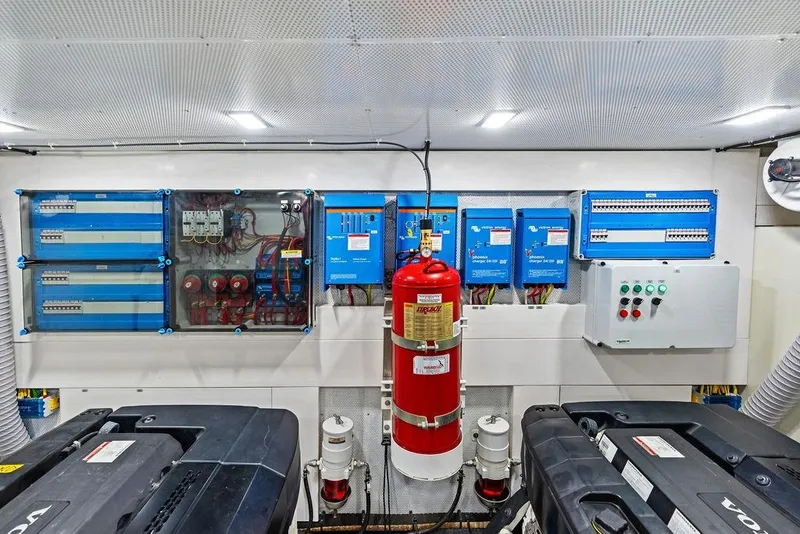 Slide: The Image of Engine room of 2022 Galeon 640 Fly yacht with electrical panels and fire extinguisher. - 106