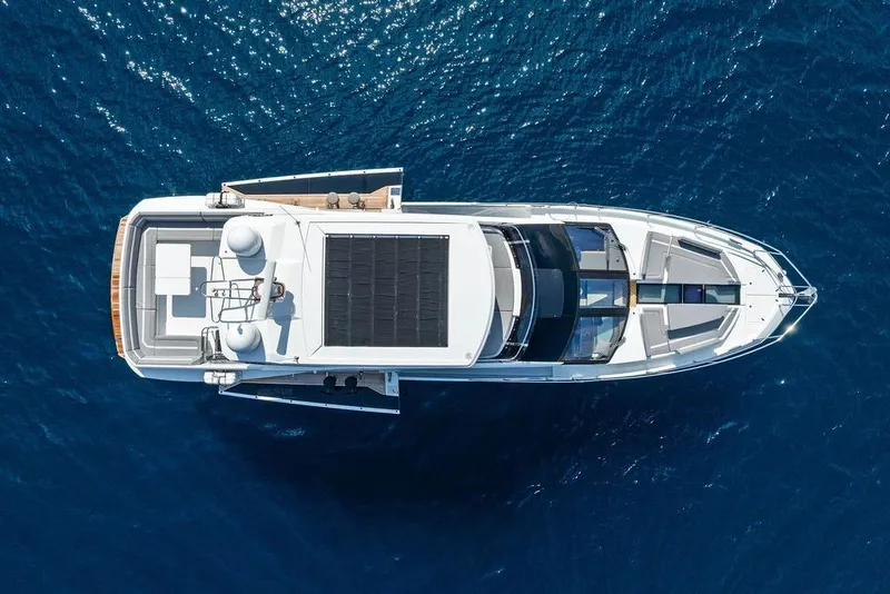 Slide: The Image of Aerial view of 2022 Galeon 640 Fly yacht on blue ocean water. - 13