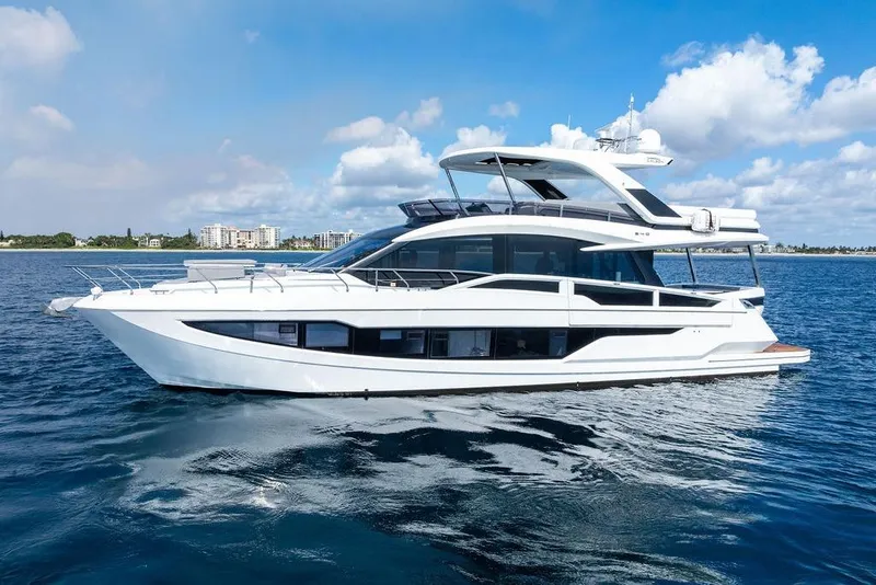 Slide: The Image of 2022 Galeon 640 Fly yacht cruising on open water under a clear blue sky. - 2