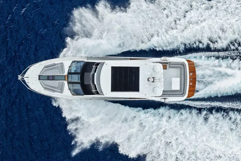 Slide: The Image of Aerial view of 2022 Galeon 640 Fly yacht cruising on blue ocean waters. - 22
