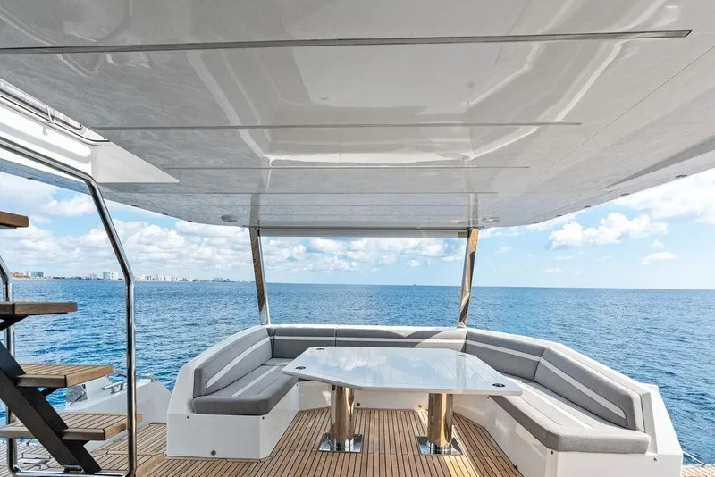 Slide: The Image of Luxurious 2022 Galeon 640 Fly yacht deck with ocean view, featuring elegant seating and table. - 25