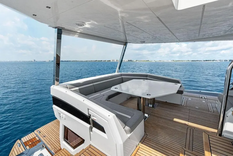 Slide: The Image of Luxurious 2022 Galeon 640 Fly yacht deck with seating, overlooking serene ocean view. - 26