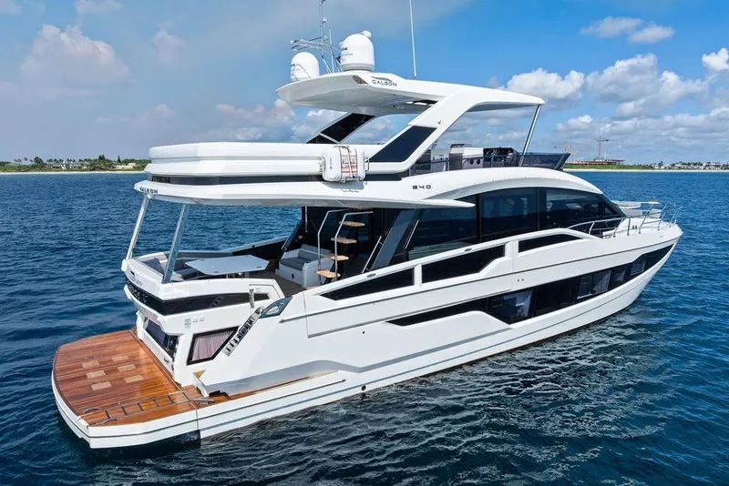 Slide: The Image of 2022 Galeon 640 Fly yacht cruising on open water under a clear blue sky. - 3