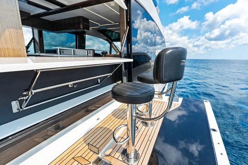 Slide: The Image of Luxury Galeon 640 Fly yacht deck with bar stools, ocean view, 2022 model. - 30