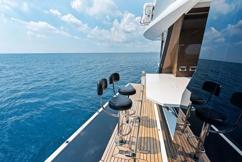 Slide: The Image of Luxurious 2022 Galeon 640 Fly yacht deck with bar stools overlooking the ocean. - 31