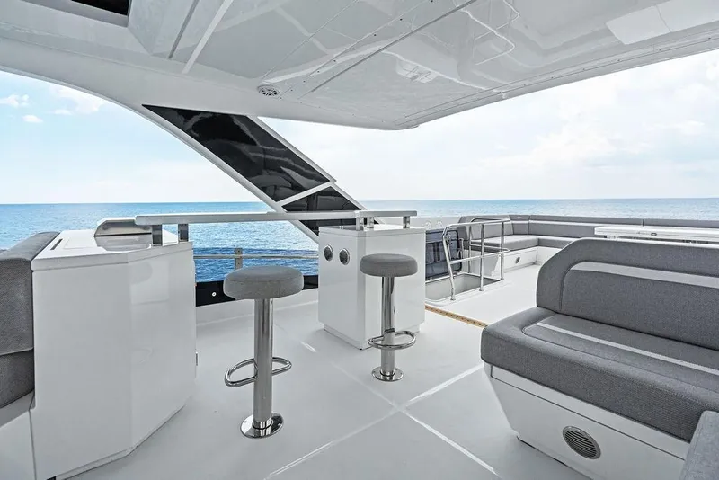 Slide: The Image of Luxurious 2022 Galeon 640 Fly yacht interior with ocean view, featuring modern seating and bar area. - 39