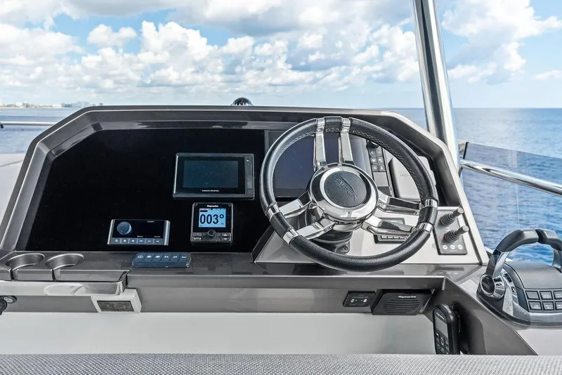 Slide: The Image of Cockpit of 2022 Galeon 640 Fly yacht with modern steering and navigation controls. - 47