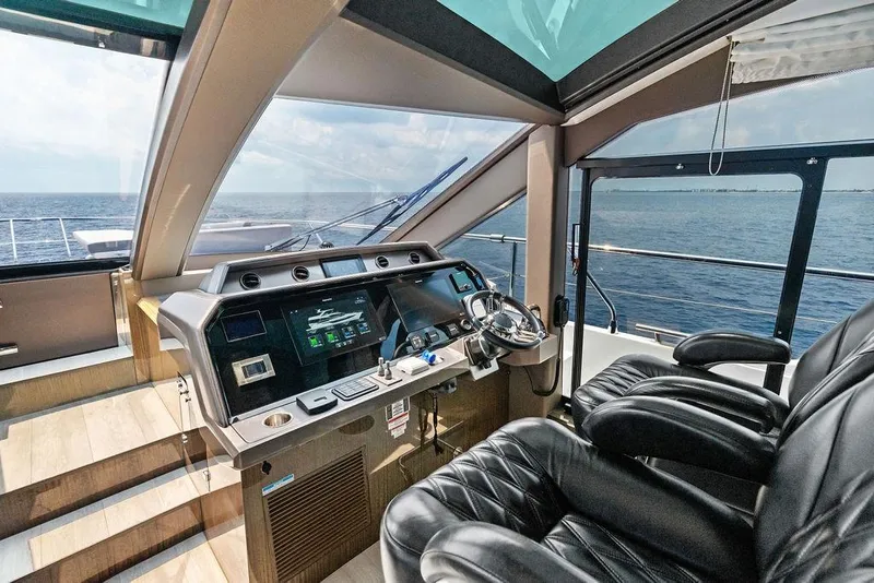 Slide: The Image of Luxurious 2022 Galeon 640 Fly yacht cockpit with modern controls and ocean view. - 74