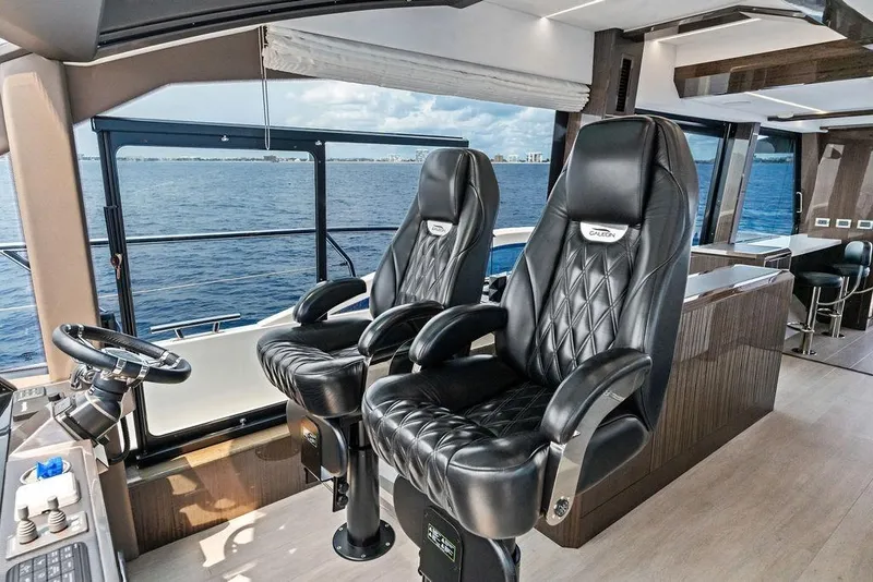 Slide: The Image of Luxurious interior of 2022 Galeon 640 Fly yacht with leather captain chairs and ocean view. - 75