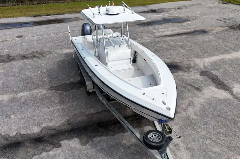 Slide: The Image of 2003 Jupiter 27 boat on trailer, aerial view, parked on concrete surface. - 13