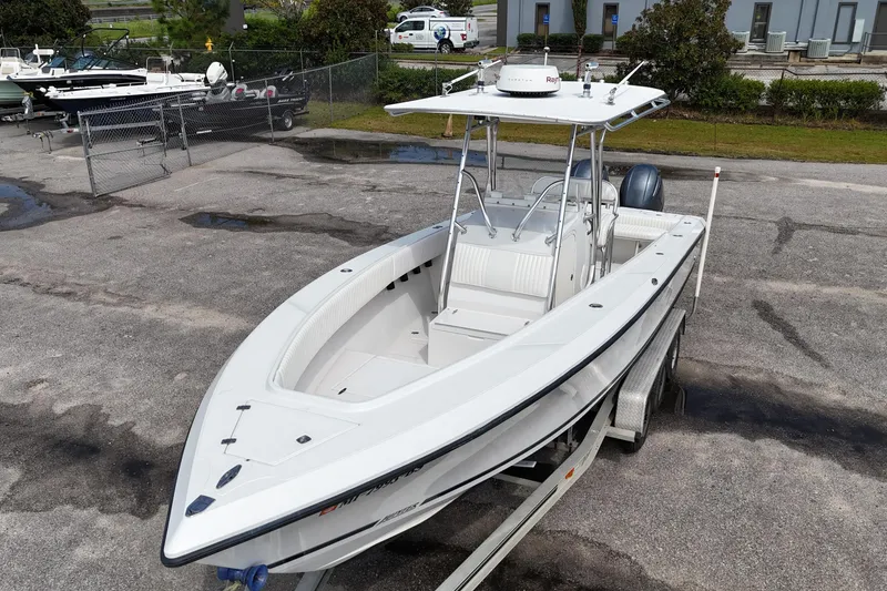Slide: The Image of 2003 Jupiter 27 boat on trailer, parked in a marina lot. - 14