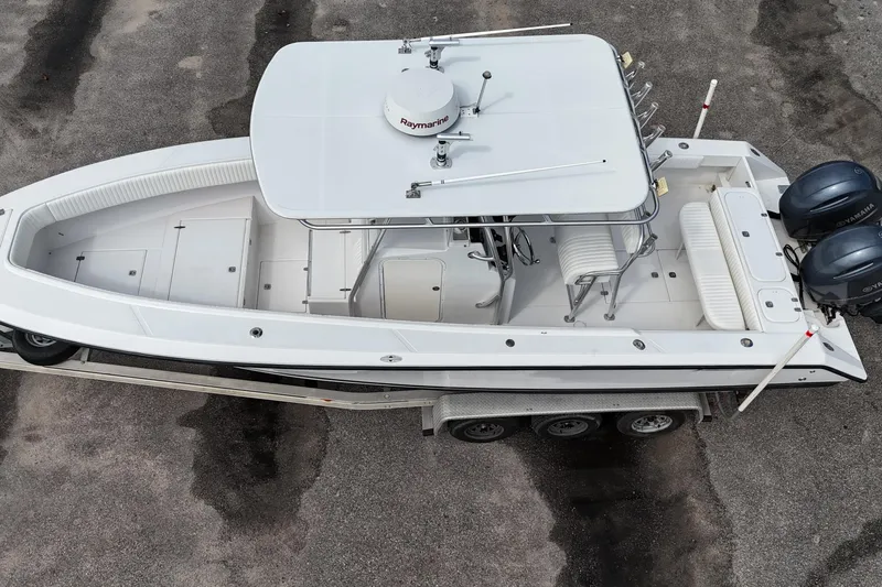 Slide: The Image of Aerial view of 2003 Jupiter 27 boat with dual Yamaha engines on a trailer. - 15