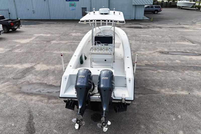 Slide: The Image of 2003 Jupiter 27 boat with dual 200 horsepower engines in a parking lot. - 16