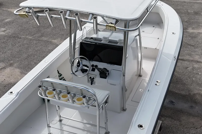 Slide: The Image of 2003 Jupiter 27 boat interior with steering console and rod holders. - 18