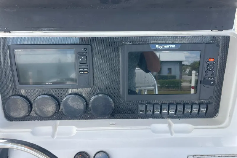 Slide: The Image of Twin outboard motors on a 2003 Jupiter 27 boat, viewed from above. - 23